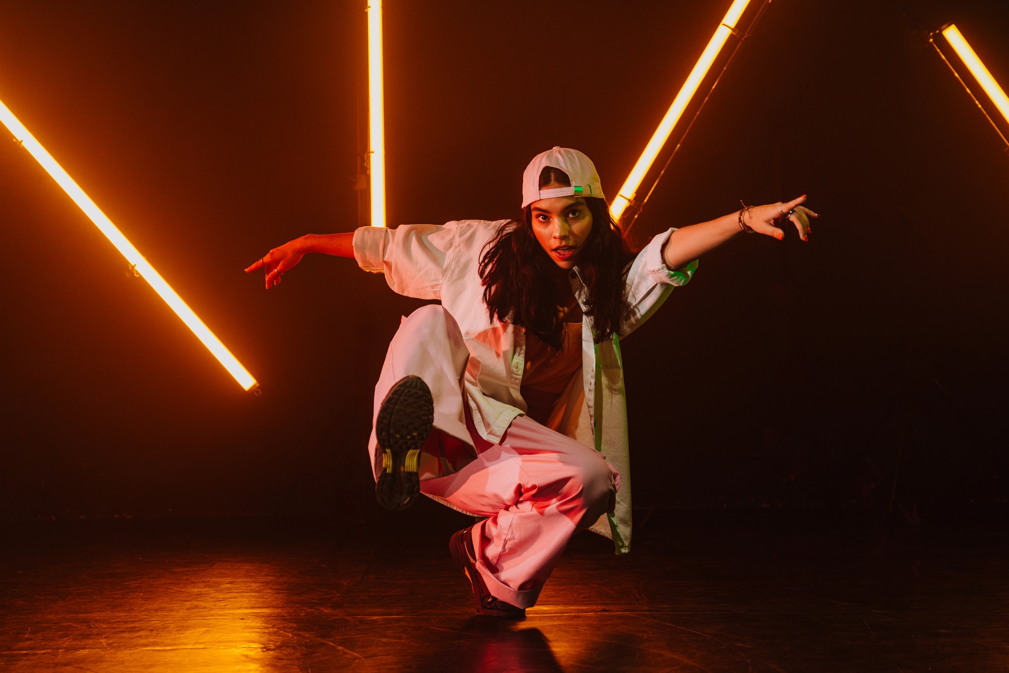 Hip hop dancer dancing in a cool studio with neon lights.
